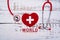 World Red Cross day. Red heart with Stethoscope on wooden table background