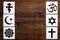 World religions concept. Christianity, Catholicism, Buddhism, Judaism, Islam symbols on wooden background top view copy