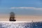 The world`s largest sailing ship leaves at sunset in the open sea