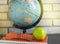 World teacher's Day at school. Still life with books, globe, Apple, glasses, sunlight