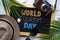 World Tourism Day Typography. Sunglasses, Fedora Hat, Palm Leaf, Camera, Sea Shells and Blackboard