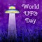 World UFO Day. Flying saucer over the meadow shines a beam