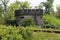 World war II small concrete bunker shaped like castle abandoned next to railway tracks and surrounded with overgrown trees and for