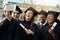 World, were coming for you. a group of students taking selfies with a mobile phone on graduation day.