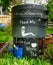 Worm farm, wormery, compost bin in organic garden with sign for Free Worm Tea, feed me and kitchen waste in here