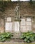 Worn ancient statue and wall plaques in the garden outside the Basilica of Sant\'Apollinare in Ravenna, Italy.