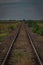 Worn and bent railorad tracks between the fields in Romania. Poor shape of railway tracks through the fields