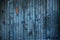 Worn blue metal garage door with rust and scratch marks for background