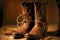 worn brown cowboy boots with rope decorations on front