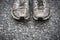 Worn, dirty, smelly and old running shoes on a tarmac road