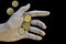 Worn doll hand holding euro coins