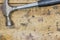 Worn hammer on scratched workbench surface