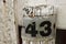 Worn metal sign with the number 43 on it