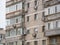 Worn out apartment building from the communist era against blue sky in Bucharest Romania.