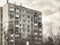 Worn out apartment building from the communist era against blue sky in Bucharest Romania.