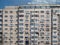 Worn out apartment building from the communist era against blue sky in Bucharest Romania. Ugly traditional communist housing