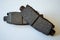 Worn out ruined disc brake pad compared to one that is new