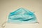 Worn out surgical mask blue colour, top view