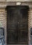 Worn sign and wooden doors for the Cavern Church known as Abu Serga in Coptic Christian Cairo, Egypt.