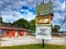 Worn signage pole front shopping strip center orange poles Tampa Florida