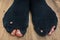 Worn socks with a holes and a fingers sticking out of them