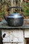 Worn teapot on old stove