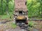 Worn and weathered chimney and fireplace with holes in it