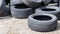 Worn wheels for recycling. Plant for burning tire dumps. Mountain of old tires. Used wheel junkyard. Pile of old tires