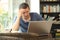 Worried adult man checking laptop content in a coffee shop