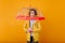 Worried beautiful girl with short hair standing under umbrella. Studio portrait of upset caucasian woman in raincoat