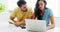 Worried couple calculating their bills with laptop in the kitchen