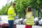 Worried Couple Looking At Broken Car