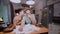 Worried couple looking at their bills in the kitchen at home. Man and woman calculating domestic accounts.