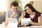 Worried couple reading together a letter