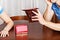 Worried couple sitting at the table with empty wallets