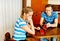 Worried couple sitting at the table with empty wallets