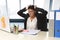 Worried and desperate businesswoman suffering stress working at office computer desk