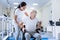 Worried disabled man sitting in a wheelchair and looking at his doctor