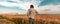 Worried farmer in barley field on a windy day