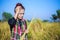 Worried farmer woman in rice field