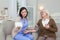 Worried female caregiver controlling blood pressure