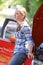 Worried Female Motorist Standing Next To Broken Down Car