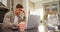 Worried man using his calculator while working on laptop 4K 4k