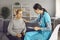 Worried mature woman talking to nurse or doctor who& x27;s comforting and supporting her