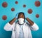 Worried medic is worried and afraid of the covid 19 corona virus. Blue background