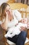 Worried Mother Holding Baby In Nursery