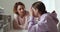 Worried mum comforting solacing upset crying teenage daughter at home