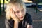 Worried, sad child alone in school playground