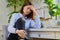 Worried sad young woman sitting on chair at home