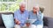 Worried senior couple looking at document